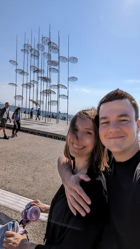 Selfie of my partner smiling and walking on the beach in Thesaloniki