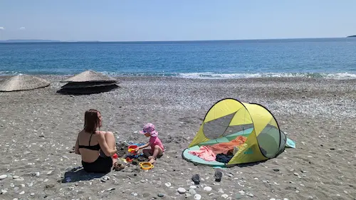 My daughter and fiance playing in the sand on a beach in Greece.