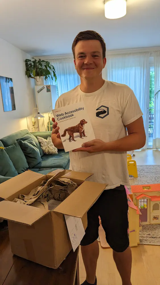 Me holding the web accessibility cookbook and smiling infront of the first package I got from the publisher.